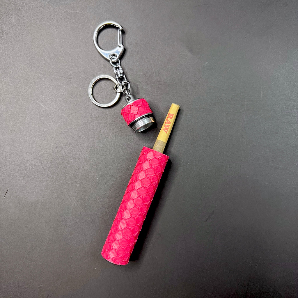 Pink python embossed joint carrier opened showing pre-roll inside