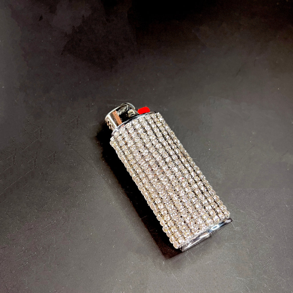 Elegant iced-out lighter case with shimmering crystal embellishments, perfect for stylish smoking accessories.