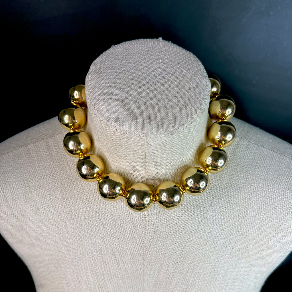 Fashion editorial look featuring oversized gold choker necklace – modern statement accessory