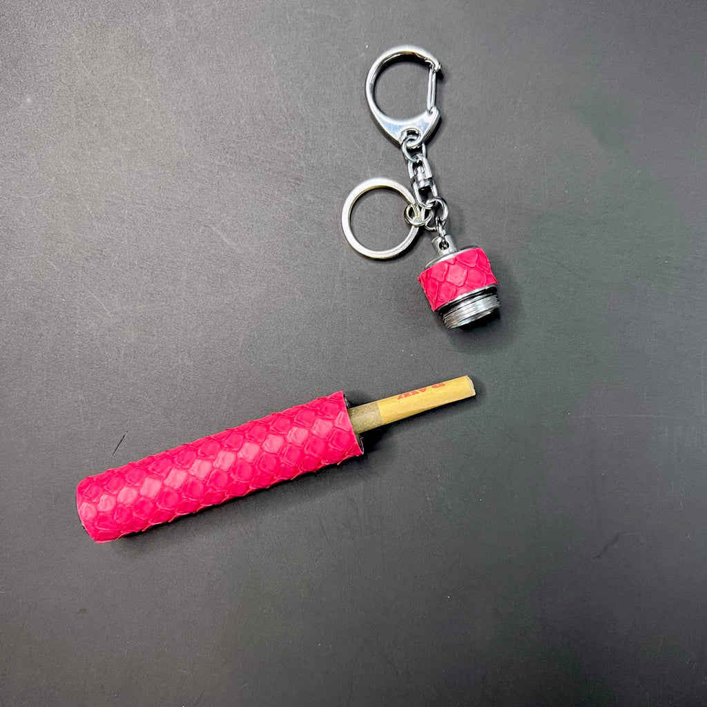 Pink python embossed joint carrier opened showing pre-roll inside
