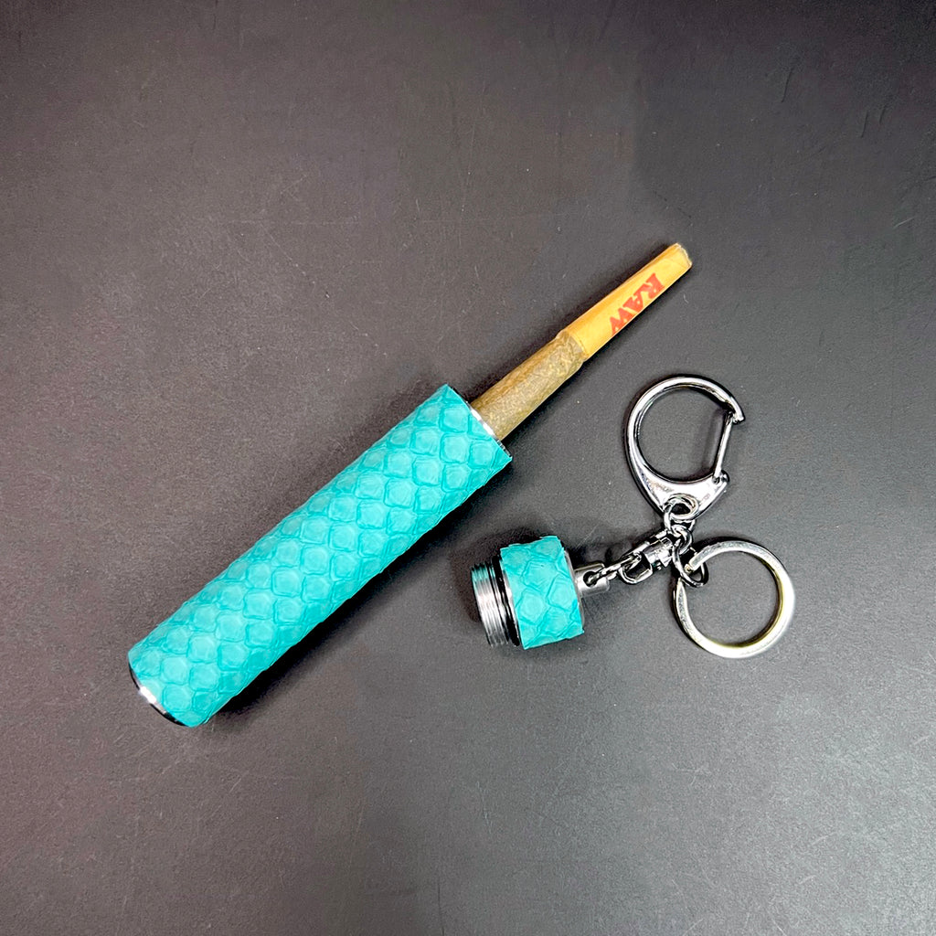 Python-wrapped Tiffany blue keychain with opened stash tube showing a RAW joint