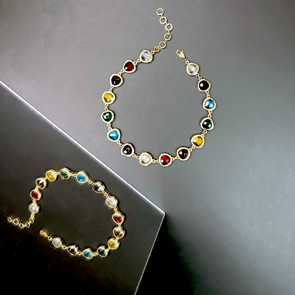 Multicolor gem statement necklace with a reflection on glossy surface, showcasing high shine and glamor