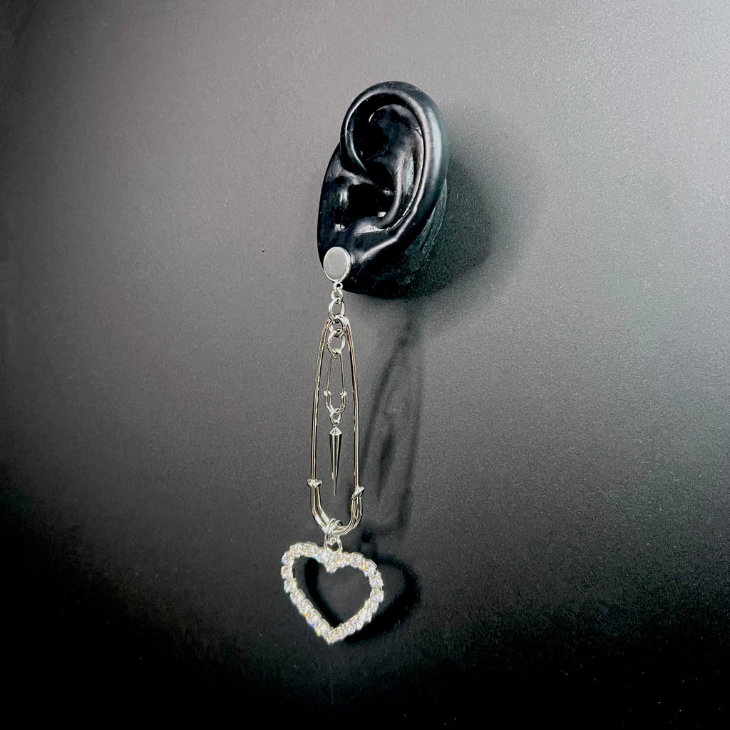 Contemporary silver heart drop earrings styled with safety pin hardware – bold fashion accessory