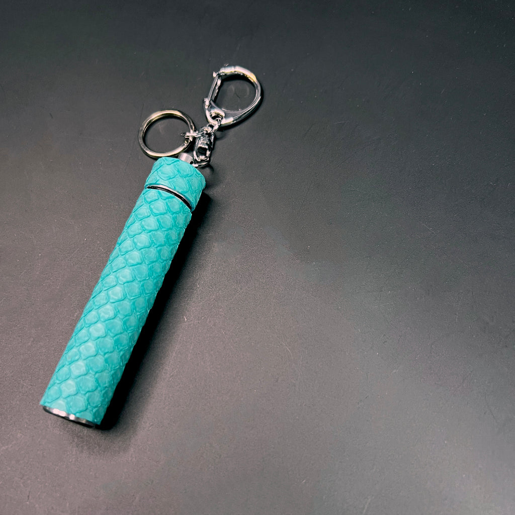 Stylish python-textured Tiffany blue joint carrier with removable cap and keyring
