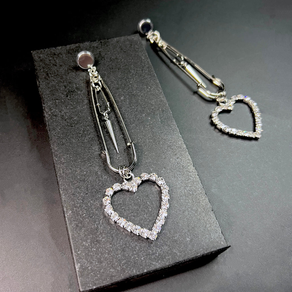 Polished silver safety pin earrings with heart detail – modern statement jewelry for women