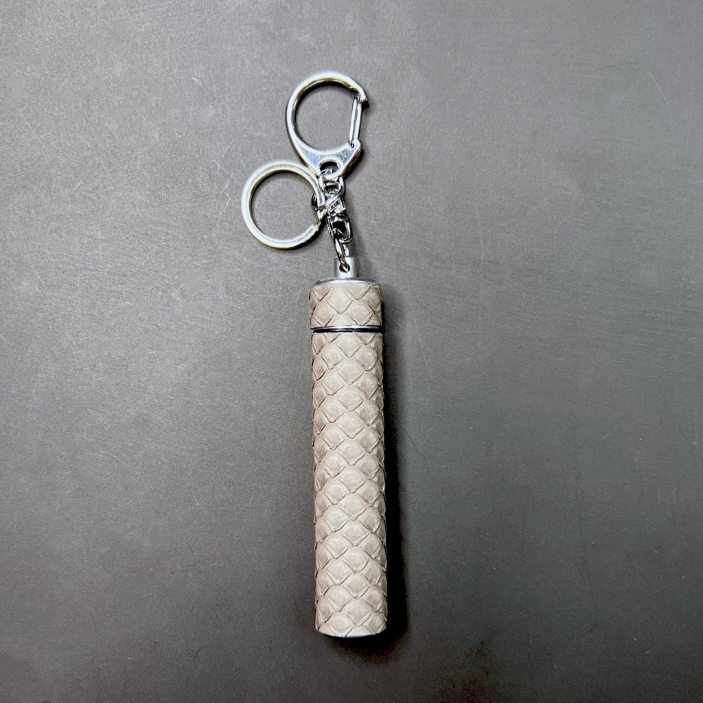 Close-up of python texture on Storm Grey J carrier with silver hardware keyring attachment