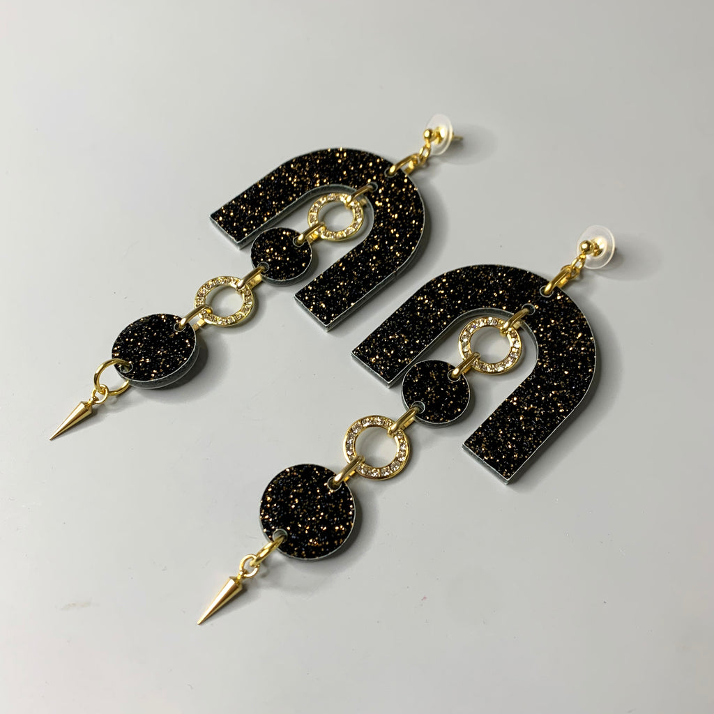 Side angle of the Disco Noir Earrings showing the sparkle detail and gold accents of these statement earrings