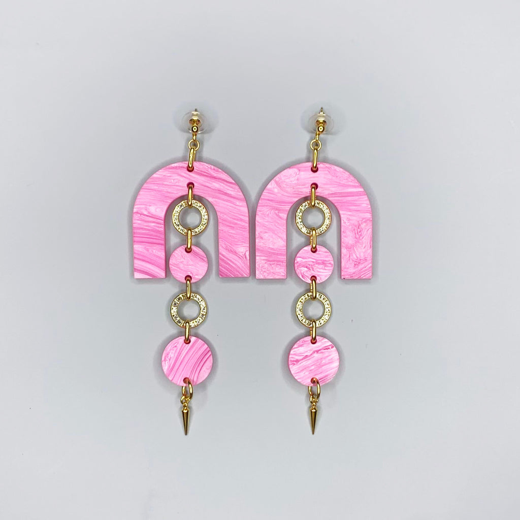 Lightweight retro-style pink acrylic earrings with sculptural arches and sparkly accents