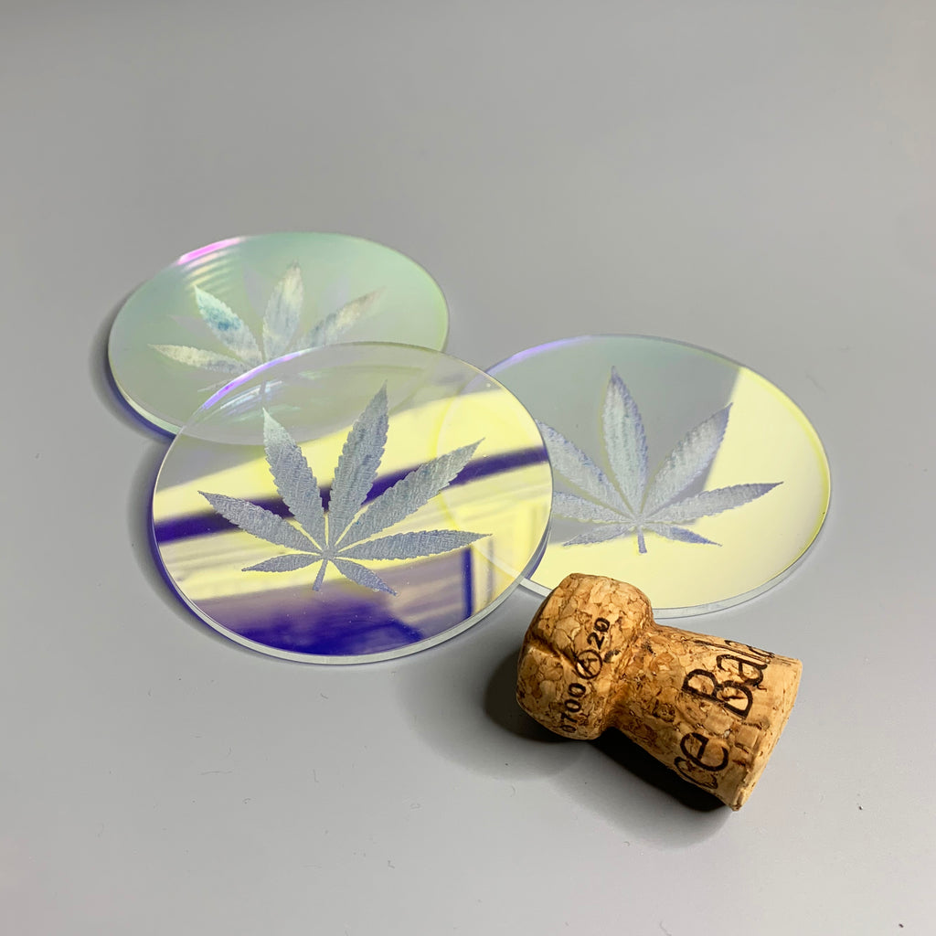 Iridescent acrylic drink coaster engraved with a pot leaf