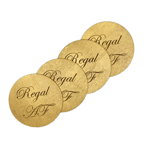 Round wood drink coasters coated in metallic enamel engraved with Regal AF