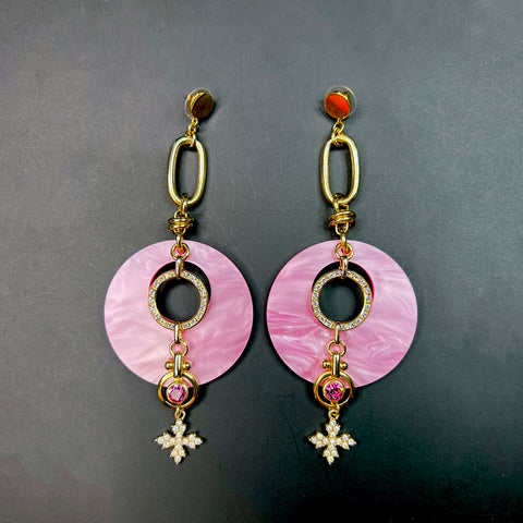 Pink and gold statement earrings with pearlized acrylic discs, crystal rings, pink gemstones, and starburst charm – bold glam fashion jewelry for women