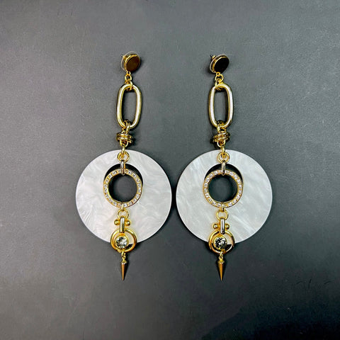 Pearlized white and gold statement earrings with crystal-studded rings, sculptural links, and spiked drop – bold fashion jewelry for women