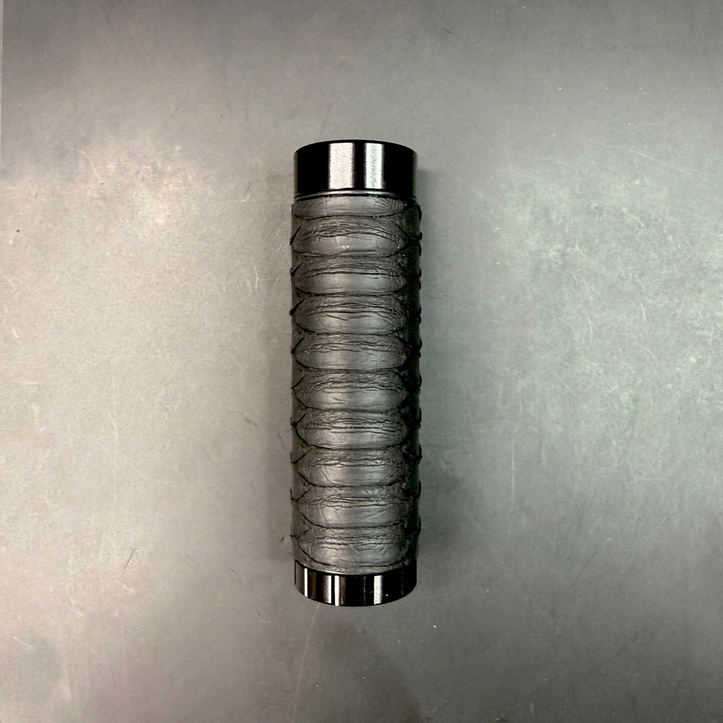 Full view of the Matte Black Python Dugout standing upright on a dark background, showing the smooth matte texture and scale pattern.