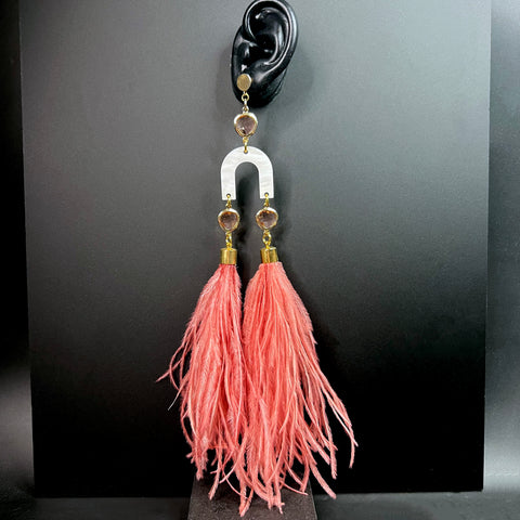 Statement earrings with blush pink feather tassels, white arched acrylic, and gold and pink gemstone details