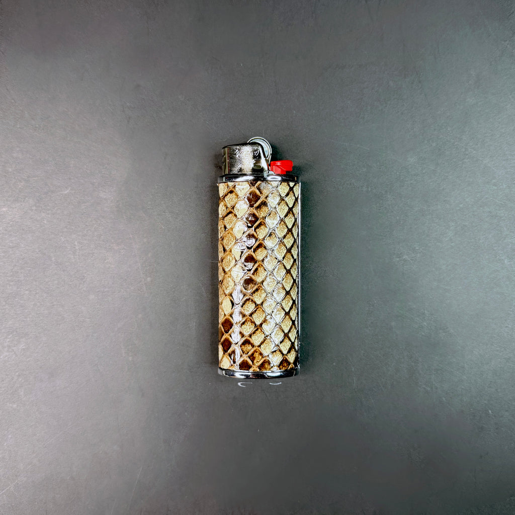 Gunmetal Lighter case with Burmese python snake skin pattern on a gray background