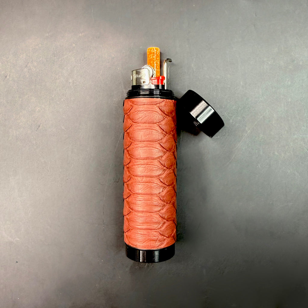 Open Matte Syrah Python Dugout with the top removed, revealing the interior setup with lighter, one-hitter, and poker tool against the black hardware.