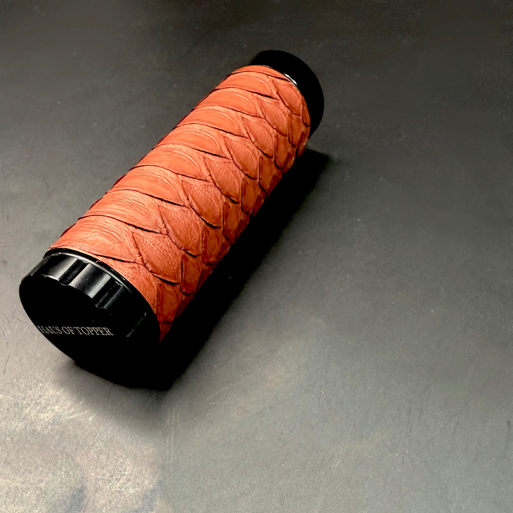 Angled close-up of the Matte Syrah Python Dugout lying on its side, highlighting the texture of the python scales and “Haus of Topper” logo on the base.