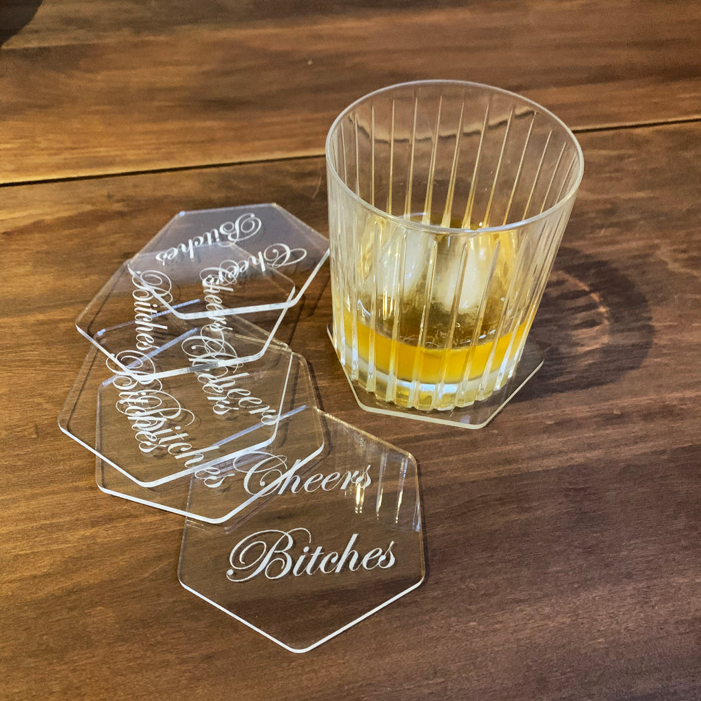 clear hexagon acrylic coasters engraved with the phrase Cheers Bitches